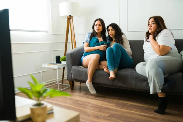 Scared Female Friends Sleepwear Relaxing Sofa Looking Afraid While Watching — Stock Photo, Image