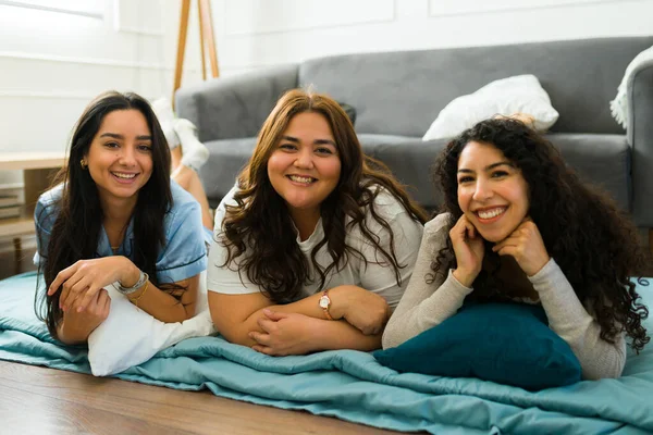 Portrait Attractive Female Friends Smiling Looking Camera Relaxing Pajamas Sleepover — Stockfoto