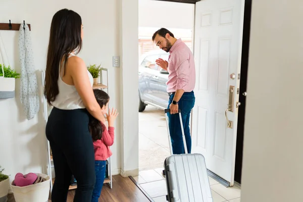 離婚後家を出る間に娘と母にさよならを振ってスーツケースを使用して悲しいお父さん — ストック写真