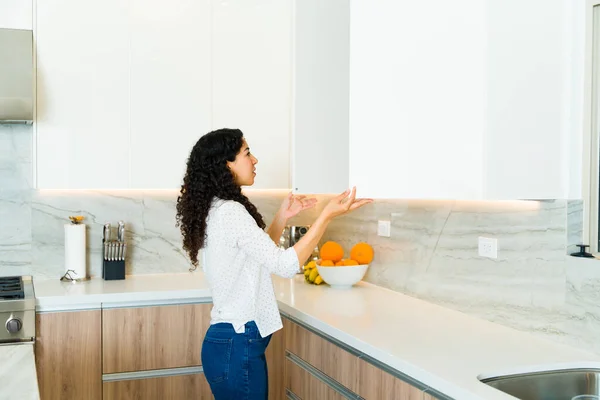 Latin Young Woman Opening Her Quartz Cupboard Looking Plates Her — Stock Photo, Image
