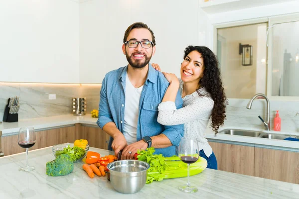 在美丽的厨房里 快乐的年轻女人和男人微笑着 眼神接触 一起烹调健康的食物 — 图库照片