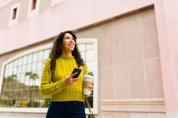 迷人的20多岁的女人在城市里散步 用手机发短信与朋友保持联系 — 图库照片