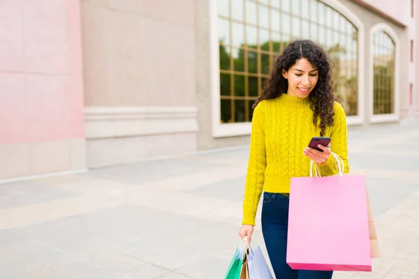 快乐的高加索女人在购物后带着很多包出去购物 开心地发短信 — 图库照片