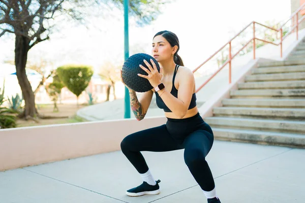 Fit Sporty Young Woman Doing Squats Using Slam Ball Outdoors — Stock Photo, Image