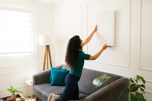 Rear View Young Woman Putting Picture Wall Decorations Living Room — Stock Photo, Image