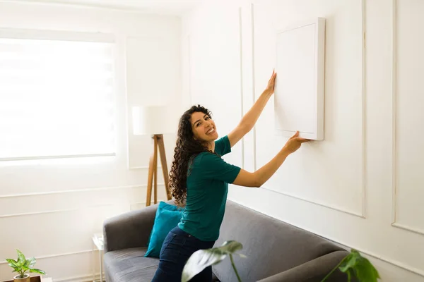 Happy Beautiful Woman Looking Camera While Putting Pictures Wall Decorations — Stock Photo, Image