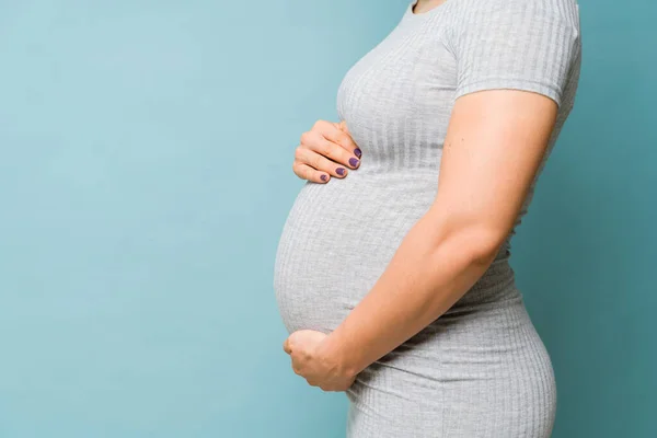 Profile View Body Pregnant Woman Embracing Her Belly Studio Blue — Stock Photo, Image