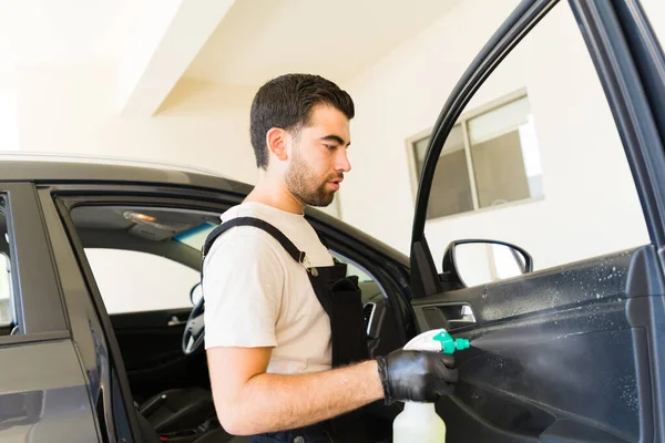 Attractive Latin Male Worker Spraying Cleaner Interior Car Door Panel — Stock Photo, Image