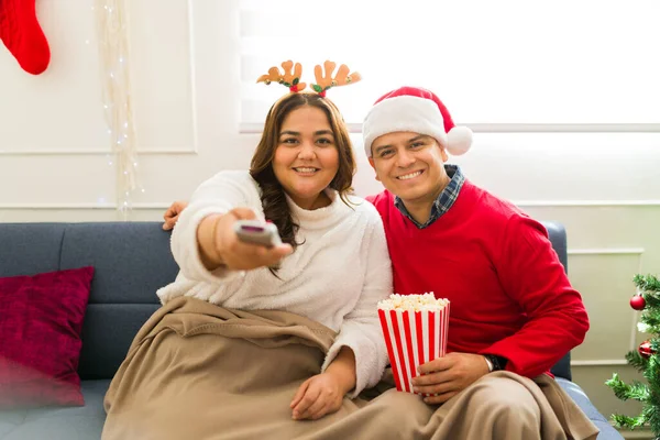 Happy Attractive Woman Smiling Using Remote While Watching Holiday Movies — Stock Photo, Image