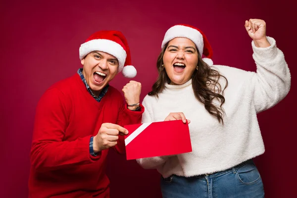 Excited Happy Couple Wearing Santa Hats Celebrating Winning Mockup Gift — Stock Photo, Image