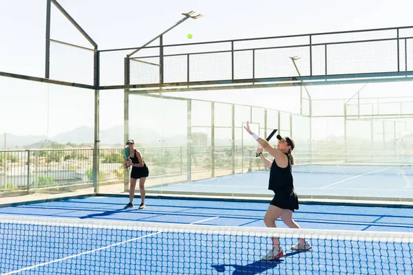 Beautiful women team training outdoors on the tennis court and playing a padel match having fun