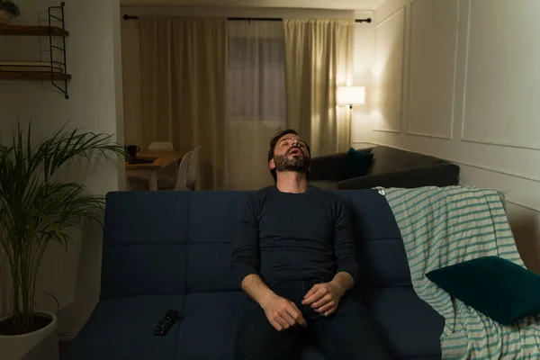 Exhausted Latin Man Looking Tired While Sleeping Couch Home Watching — Stock Photo, Image