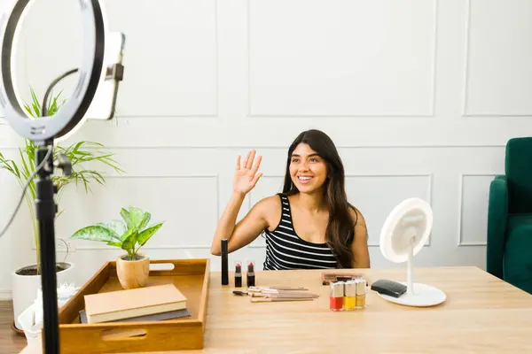Young Woman Waving Camera While Creating Beauty Content Home Royalty Free Stock Photos
