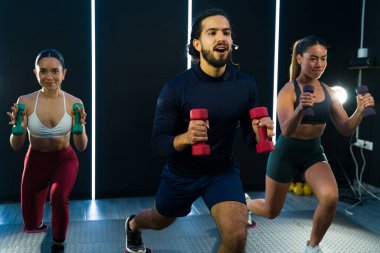 Jimnastik eğitmenleri mikrofon kullanıyor ve çevrimiçi fitness sınıfı için yeni bir egzersiz kaydediyor.