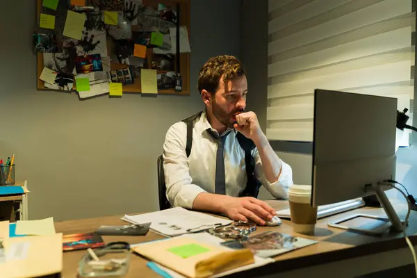 Thoughtful Investigator Examines Evidence Cluttered Dimly Lit Office Environment Stock Image