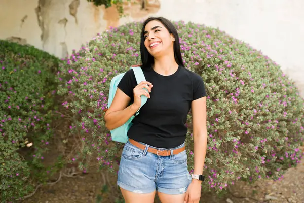Joyful Hispanic Woman Wearing Black Shirt Mockup Stands Floral Background Stock Picture