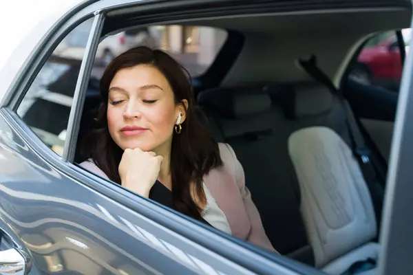 Tranquil Businesswoman Unwinding Backseat Car Closed Eyes Listening Music Smooth ภาพสต็อก