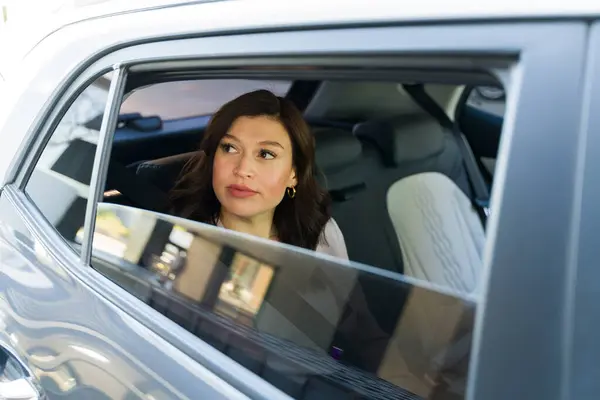 Professional Businesswoman Riding Car Looking Out Window Reflecting Her Day รูปภาพสต็อก