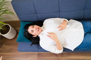 Top view of a female patient during a therapy session, discussing mental health issues with her psychologist in a comforting setting