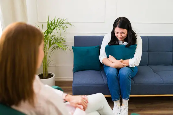 stock image Woman psychologist listens attentively to a patient expressing emotional pain during a mental health therapy session in a comfortable setting