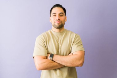 Kollarını kavuşturan genç bir İspanyol 'un portresi canlı mor bir arka plana karşı güven ve güç aktarıyor.