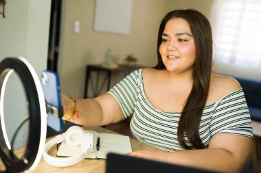 İçerik yaratıcısı olarak çalışan, akıllı telefon ve halka ışığı kullanarak bir video bloğu kaydeden büyük ölçekli bir nüfuz sahibi.