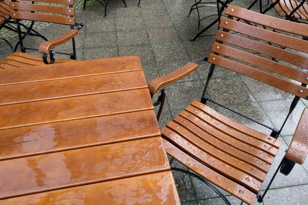 stock image Empty outdoor furniture after the rain on the cafe terrace