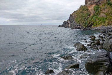View of the turquoise water of the Atlantic Ocean, washes the coast of the island of Madeira