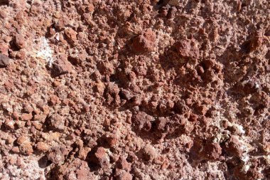 Red volcanic earth. Ground background texture, volcanic