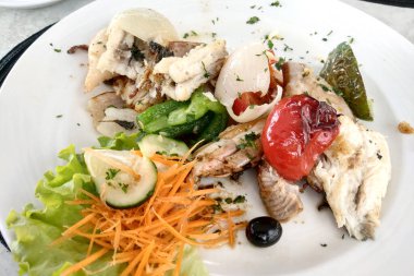 Close-up of a dish of fresh fish and vegetables