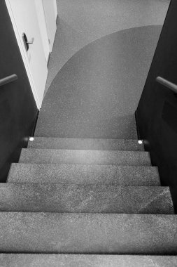 Black and white photo. The background of the modern staircase in the house