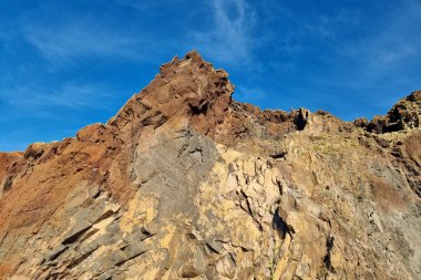 Beautiful red and yellow rocks on the island of MAdeira. Volcanic rocks
