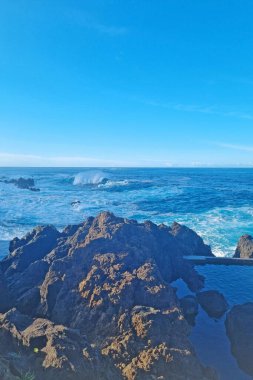 Blue waves of the sea or ocean roll ashore