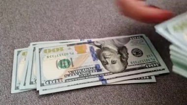 Bir kadın bir tomar dolar sayar. Mali hesaplamalar