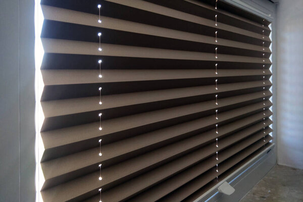 View of the roller blinds in the room. Light protection