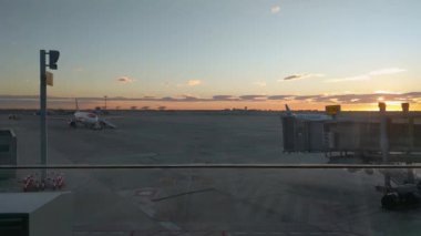 Barselona, İspanya, 24 Aralık 2024: Airport Runway 'de uçak ve biniş kapısı manzaralı gün batımı