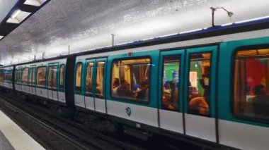 Paris, France, August 4, 2025: A bustling subway train glides through a well-lit underground station, filled with diverse passengers. the modern design and vibrant atmosphere reflect urban daily life, showcasing fast-paced metropolitan commuting.