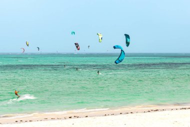 Kite surfing in ocean in Paje beach, Zanzibar, Tanzania. Extreme summer water sport, acitve holiday