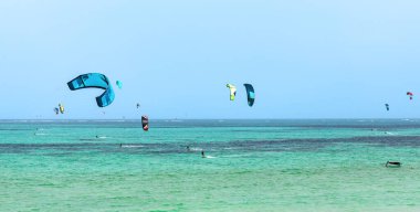 Kite surfing in turqoise Indian ocean in Paje, Zanzibar. Summer extreme water sports 