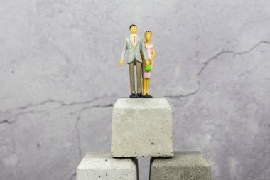 Yaşam başarısı güçlü bir zafer kazandı. Bir çift erkek ve bir kadın beton blokların tepesinde gururla duruyordu. Beton blokların tepesinde gururla duruyorum Yaşam başarısı güçlü