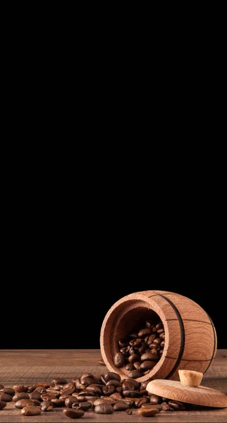 Wooden container for storing coffee beans on a black background for advertising