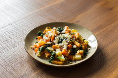 Steaming vegetable stew in a plate at the modern kitchen