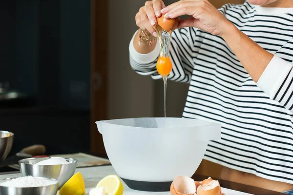 Woman Breaking Eggs While Cooking Apple Pie Modern Kitchen — ストック写真