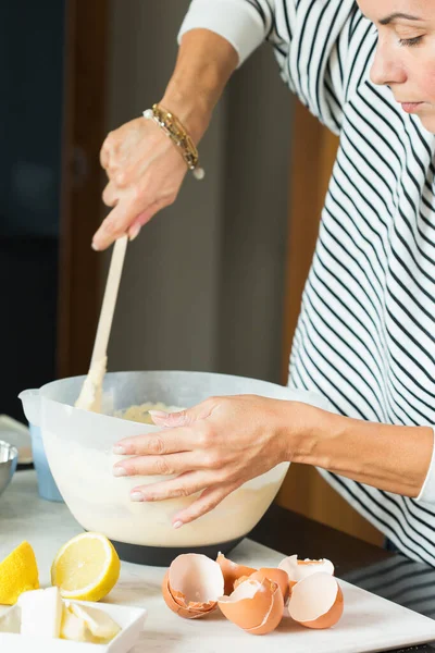 stock image Woman kneading the dough while cooking apple pie in the modern kitchen