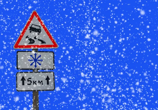 Winter road with Road sign of slippery road, direction of travel.warning sign about the snowfall on the snowy road .