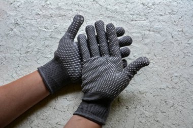 Gray working glove on hand. Open palm on isolated white background.