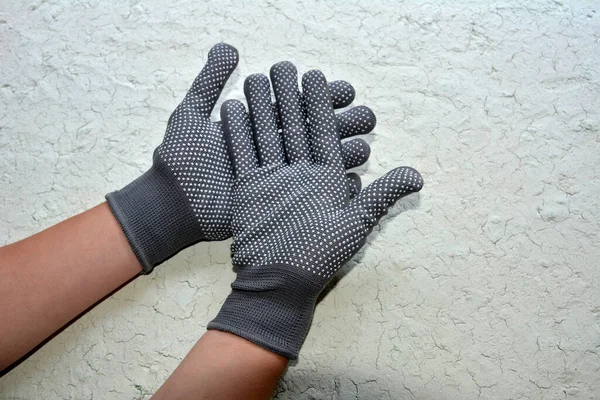 Gray working glove on hand. Open palm on isolated white background.