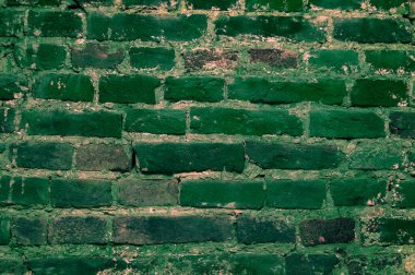 Brick wall background .A Full Frame Background Of A Rough And Textured Brick Wall With Visible Wear And Tare And Copy Space .old green brick wall texture background