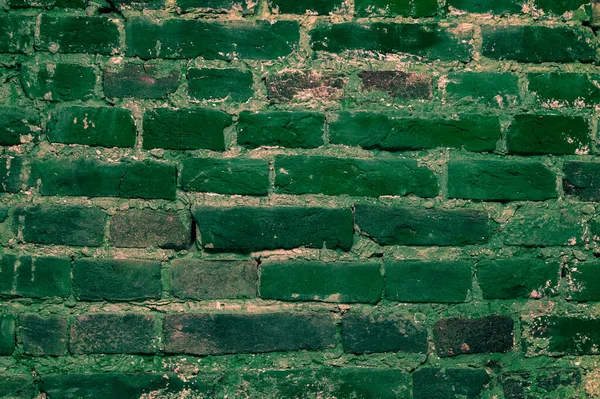 stock image Brick wall background .A Full Frame Background Of A Rough And Textured Brick Wall With Visible Wear And Tare And Copy Space .old green brick wall texture background