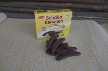 Lviv, Ukraine, March 2023.chocolate bananas ,Mini banana covered with chocolate .Mini banana and ladyfingers covered with chocolate foam.